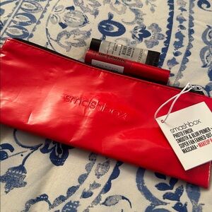 NWTs Smashbox Glossy Red Makeup Pouch include primer and mascara.